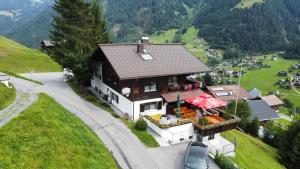 a house with a car parked in front of it at Alpinchalet Zigjam in Gaschurn