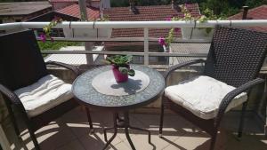 a table with a plant in a vase on a balcony at Apartments Thea in Mostar