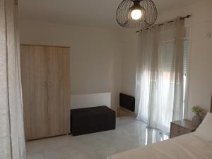 a bedroom with a bed and a cabinet and a television at GN summer guest house P in Leptokarya