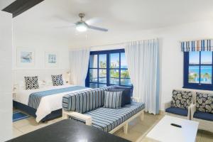 a hotel room with a bed and a couch at Kaliva 136 Club Mykonos, Langebaan in Langebaan