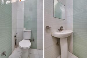 a bathroom with a toilet and a sink at Hotel O The Gomti Hotel in Dehradun