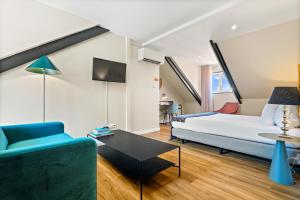 a living room with a bed and a couch at Casa do Patio by Shiadu in Lisbon