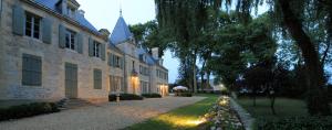 a large building with a pathway in front of it at Château de Planchevienne in Magny-Cours
