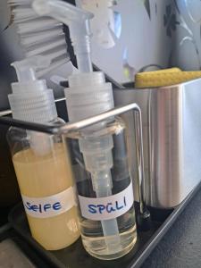 a kitchen counter with bottles of liquid and a mixer at Ferienoase Berg & See in Feldkirchen in Kärnten +34 photos