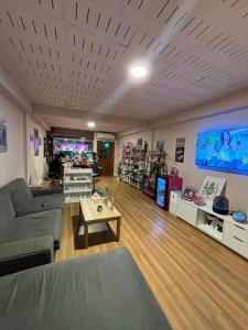 a living room with a couch and a table at Mango Hostel - 420 Friendly in Bangkok