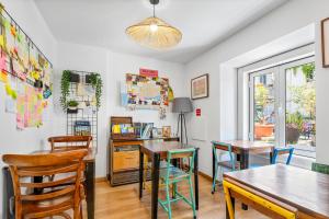a dining room with two tables and chairs at Casa do Patio by Shiadu in Lisbon