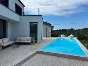 a swimming pool in the backyard of a house at Vila Solini in Kozana