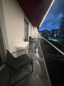 a balcony with chairs and a table on a building at Elite Apartment - Art of fine living in Cluj-Napoca
