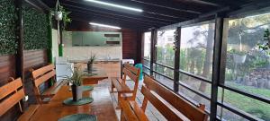 a dining room with wooden tables and benches at VILA TAMI in Costinesti