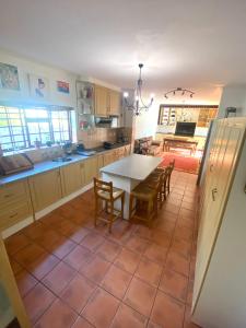 a kitchen with a table and chairs in it at Franschhoek- African dream in Franschhoek