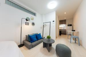 a living room with a couch and a table at FINOA Residential Suite Takaido in Tokyo