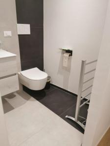 a white bathroom with a toilet and a sink at Casa della Lavanda in Sarnonico