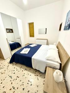 a bedroom with a large bed and a mirror at Dimora Anastasia - Alloggio nel cuore di Balestrate in Balestrate +10 photos