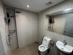 a bathroom with a toilet and a sink at Summermall suits samarahan in Kota Samarahan