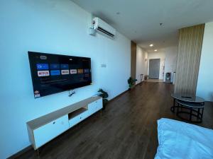 a living room with a large flat screen tv on the wall at Summermall suits samarahan in Kota Samarahan +6 photos