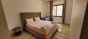 a bedroom with a bed with two towels on it at Apartment Close to Casablanca Mohamed V Airport in Nouaseur
