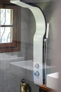 a bathroom with a shower with a sink and a mirror at Villa Stagiates in Stagiates +48 photos