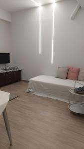 a white room with a bed and a table at Galazio suites 3 Seaside in Salamina