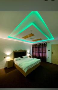 a bedroom with a bed with a blue light at Tourist haven hotel in Ponedas