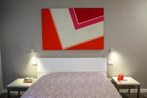Postel nebo postele na pokoji v ubytování B&B WarmUp Grosseto - Parcheggio incluso nella corte interna