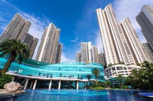 a building in front of a city with tall buildings at 3BR Luxury Seaview Suite Danga Bay Legoland in Johor Bahru