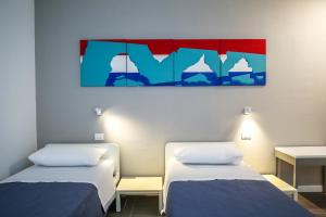 Postel nebo postele na pokoji v ubytování B&B WarmUp Grosseto - Parcheggio incluso nella corte interna