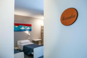 Postel nebo postele na pokoji v ubytování B&B WarmUp Grosseto - Parcheggio incluso nella corte interna