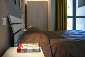Postel nebo postele na pokoji v ubytování B&B WarmUp Grosseto - Parcheggio incluso nella corte interna