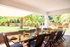 a dining room with a table and chairs at Villa 8br, Sea Views, Walk To The Beach, Pool in Santa Eularia des Riu