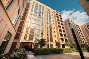 a large building with many windows in a city at Al Mamsha Luxury Apartment With Balcony in Sharjah