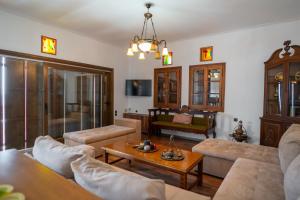 a living room with a couch and a table at Villa Stagiates in Stagiates