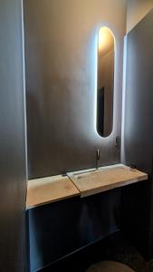 a bathroom with a sink and a mirror at Le Mtx Marché in Montreux +17 photos