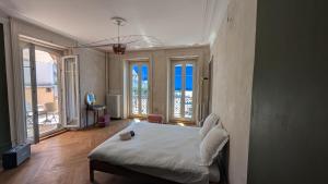 a bedroom with a bed and large windows at Le Mtx Marché in Montreux