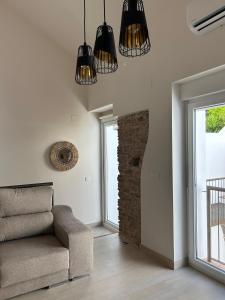 Una sala de estar con un sofá y una chimenea de piedra. en Puerta de los Castañares A, en Constantina 17 fotos más