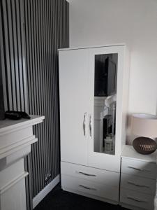 a white cabinet with a mirror in a room at Southfield lodge in Middlesbrough +49 photos