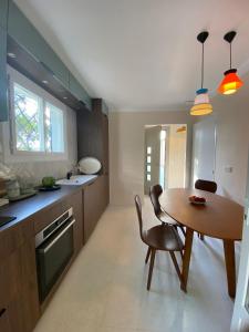 a kitchen with a wooden table and a dining room at Villa and independent studio St Raphaël Agay in Saint-Raphaël +29 photos