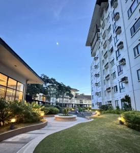 a courtyard of a building with a fountain in front of it at Tagaytay Staycation with Great Location in Tagaytay