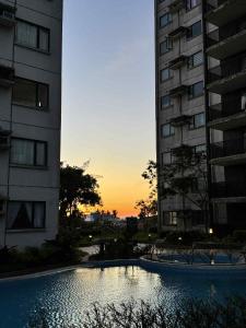 a swimming pool in front of two tall buildings at Tagaytay Staycation with Great Location in Tagaytay +13 photos