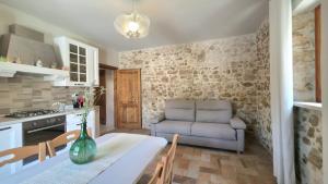 a kitchen and dining room with a table and a couch at Il Casale di Papà in Piemonte