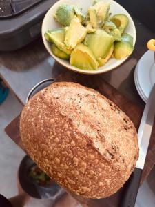 a plate of bread and a bowl of vegetables on a counter at Ananda Home in Tân Hiệp
