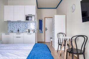 a room with a kitchen and a table and chairs at Anmut by Revelton in Karlovy Vary