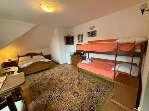 a room with two bunk beds and a rug at VITA Augustów in Augustów