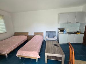 a room with two beds and a table and a kitchen at Villa Relax Apartments in Budva