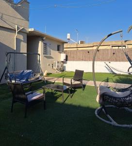 a yard with two chairs and a swing at דירה בעמק in Bet Sheʼan