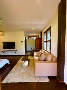 a living room with a couch and a tv at Roya Khmer Homestay in Siem Reap +68 photos