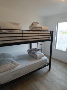 a couple of bunk beds in a room at L'écrin des Marais in Les Sables-dʼOlonne