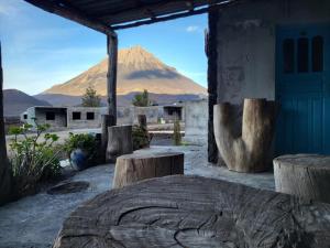 a view of a mountain from a building with logs at Pensão CasaDanilo in Portela