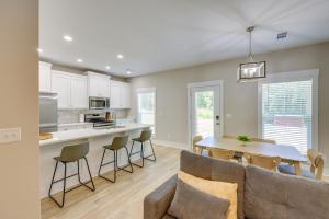 a kitchen and living room with a table and chairs at Near 17 Springs Sports Complex Millbrook Duplex! in Millbrook