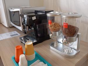 a coffee machine sitting on a counter next to a microwave at Bed end Breakfast Elisa in Caronno Pertusella