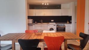 a kitchen with a wooden table and chairs at Casa Cotera in Sierra +13 photos